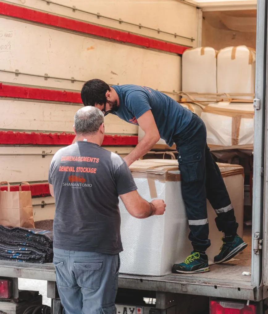 ShanAntonio movers loading a packed item into a moving truck