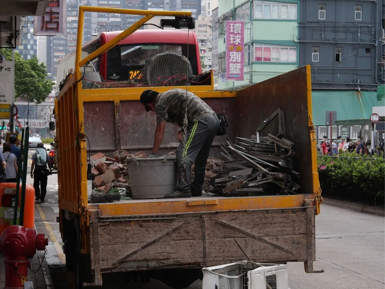 Worker loading scrap and junk into a removal truck