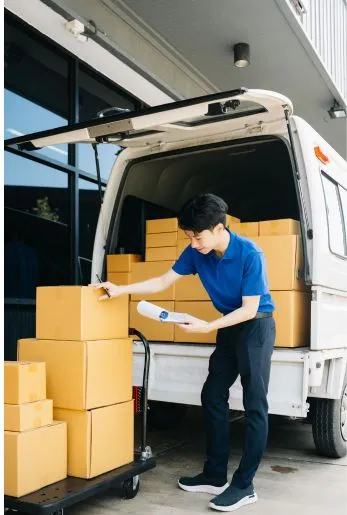 Mover unloading cardboard boxes from the back of a van